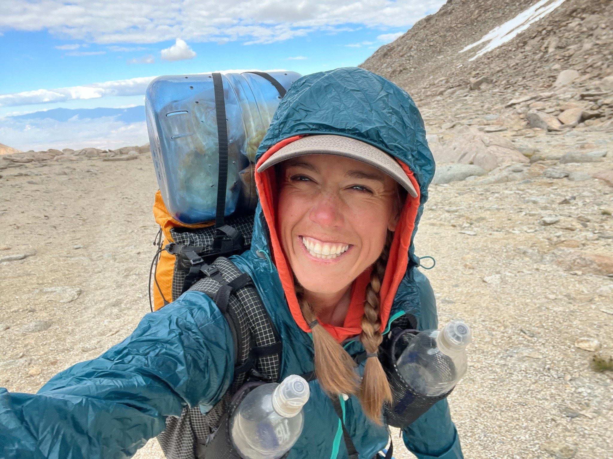 Sasha smiling on a backpacking trip