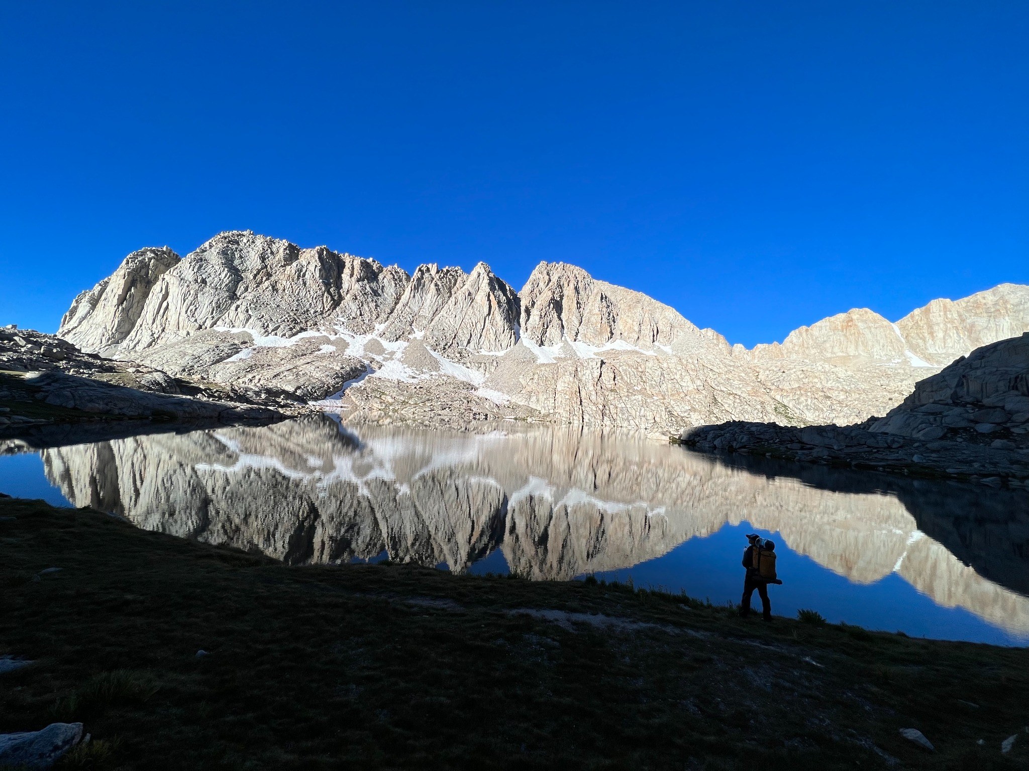 Mountains reflected in a still alpine lake