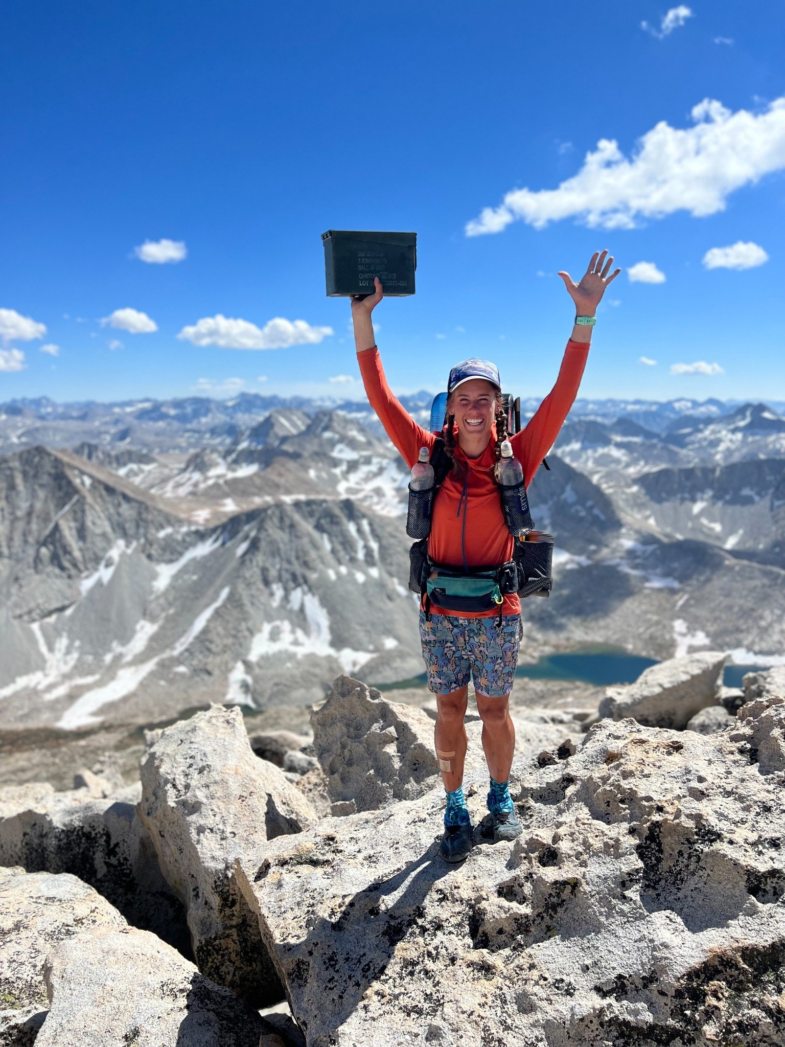 Sasha celebrating on a mountain summit